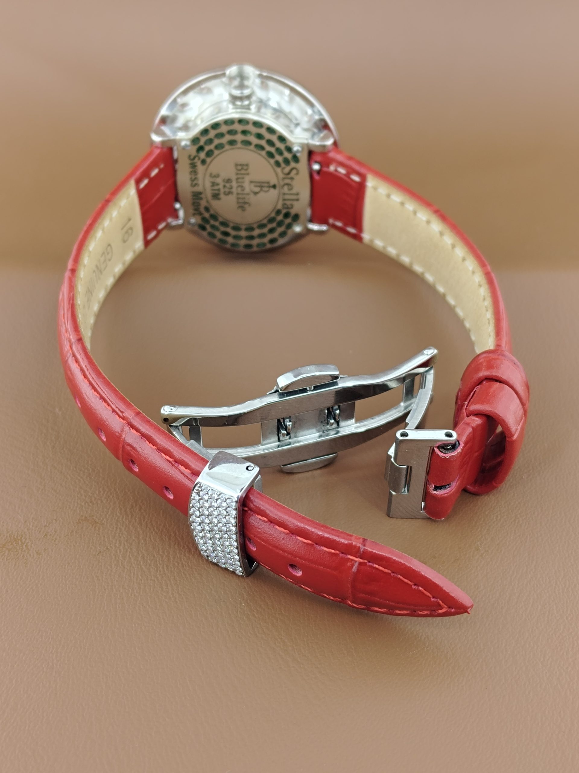 Elegant women’s diamond watch with sparkling stones, green face, and premium finish